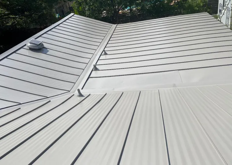 Solar attic fan installed on a metal roof for Roof Ventilation in Kerman